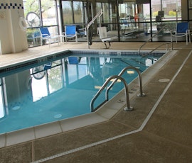 This is the back side view of the pool deck that has had a spry-textured concrete overlay installed. (thumbnail)