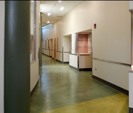 The multi-colored resurfaced concrete floor of this corridor was created with Pentimento by Duraamen. (thumbnail)