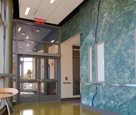 The hallways in this building at Southern Connecticut State University were resurfaced using Pentimento semi-self-leveling concrete from Duraamen. (thumbnail)