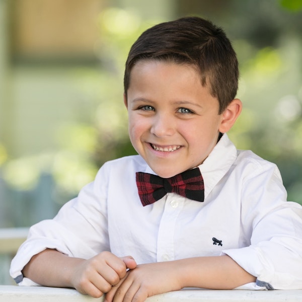 child with belts/​suspenders/​ties